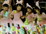 A Group of Girls Dressing as Bunny Rabbits Play with Rabbit Figures