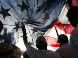 Immigration Rights Demonstrators Hold a U.S. Flag Aloft During a March Along Wilshire Boulevard