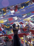 Pilgrim Praying Among Flags, Tibet