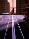 Pedestrian Crossing Cable Car Tracks on Nob Hill with Bay Bridge in Background, San Francisco, CA