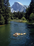 Tourists Float on a Raft in the Merced River at Yosemite National Park