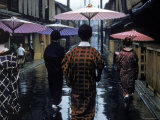 Geishas Carry Umbrellas of Oiled Japanese Paper Wearing Geta Walking in Rain, Gion Geisha Quarter