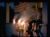 Buy Boys Sitting on Porch Holding Sparklers, with US Flag in Back, During Independence Day Celebration at AllPosters.com