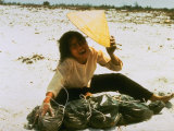 Grieving Widow Crying over the Remains of Husband Found in Mass Grave Killed in Vietnam War
