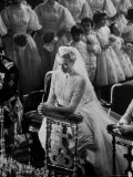 Actress Grace Kelly in Gorgeous Wedding Gown Praying During Her Wedding to Prince Rainier