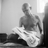 Indian Leader Mohandas Gandhi Reading as He Sits Cross Legged on Floor, at Home