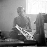 Indian Leader Mohandas Gandhi Reading as He Sits Cross Legged on Floor, at Home
