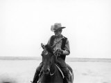 Actor James Dean Clad in Western Garb for His Role, Riding Horse on Location for the Movie "Giant"