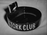 Stork Club Ashtray with a Stork Emblazoned Book of Matches on Table in This Exclusive Night Club