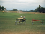 Golfers Sitting on Bench Near Practice Greens While Awaiting Tee Time on Pinehurst Golf Course