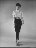 Actress Rita Moreno Wearing a Turtle Neck Sweater and Slacks walks like a 