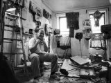 Jim Dine Sitting in Cluttered Studio/Apartment, Holding Baby on His Shoulders Premium Photographic Print