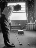 Golfer Ben Hogan Practicing Putting in His town house with Wife Valerie Watching from Armchair