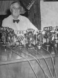 President Franklin D. Roosevelt Sitting Behind a Bank of Microphones from Various Radio Networks