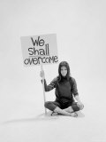 Writer Gloria Steinem Sitting on Floor with Sign "We Shall Overcome" Regarding Pop Culture