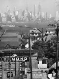 Buy Lower Manhattan and Ferry Docks with Aid of a Telephoto Lens over the Rooftops in Staten Island at AllPosters.com