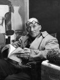 Buy Architect Le Corbusier Sitting in Chair and Holding Book in Hands at AllPosters.com