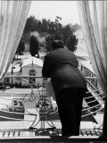 Suit Clad Movie Director Alfred Hitchcock as He Leans on Balcony Railing of Apartment