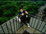 Comedian Jerry Seinfeld Perching Precariously on Roof Ledge Overlooking Central Park
