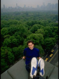 Comedian Jerry Seinfeld Perching Precariously on Roof Ledge Overlooking Central Park