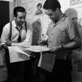 Director Walt Disney Looking over Sketches from His Latest Picture "Pinocchio."