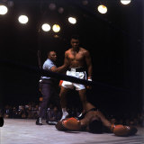Heavyweight Boxer Cassius Clay, aka Muhammad Ali, Standing over Opponent Sonny Liston