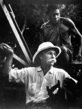 Dr. Albert Schweitzer, Medical Missionary and Humanitarian, with Carpenter at Site of His Hospital Premium Photographic Print