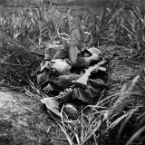 American Infantryman Terry Moore Taking Cover; Japanese Artillery Fire Explodes Nearby During
