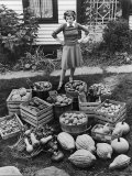 Buy Woman Looking at Victory Garden Harvest Sitting on Lawn, Waiting to Be Stored Away for Winter at AllPosters.com