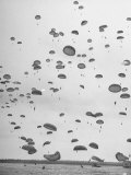 Scores of Paratroopers Dropping from C-82 "Flying Boxcar" and Landing on Level Ground