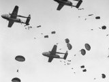 Scores of Paratroopers Dropping from C-82 "Flying Boxcar" and Landing on Level Ground