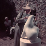 French Sculptor Jean Arp, Alone, Polishing Abstract Sculpture in His Garden Near Paris