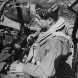 French Aviator/Author Antoine de Saint Exupery Sitting in Cockpit of Fighter Plane