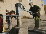 An Elderly Man Pumps Water from a Public Well in Kabul, Afghanistan, Friday, September 22, 2006