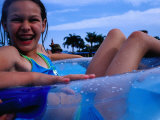 Buy Young Girl Floating in Swimming Pool in Rubber Ring, Gold Coast, Australia at AllPosters.com