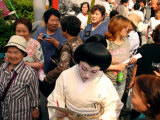 Geisha in Kimono Signing Autograph for Fan, Tokyo, Japan
