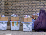 An Afghan Woman in a Burqa Oversees Ballot Boxes