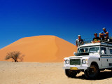 Buy Men on Four Wheel Drive Vehicle at Dune 45 in Namib Nauklaft National Park, Sossusvlei, Namibia at AllPosters.com