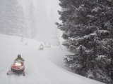Buy A Group of Snowmobilers Turn a Corner in a Snowstorm at AllPosters.com