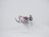 Buy A Snowmobiler Jumps from a Hill on a Snowy Day at AllPosters.com