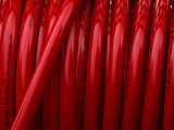 Close-up of Shiny Coiled Red Fire Hoses