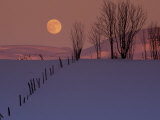 Wooden Fence in Snow Covered Field at Sunset