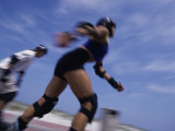 Side Profile of Two People Inline Skating
