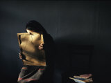 A Grieving Woman Holds a Photograph of Her Murdered Son