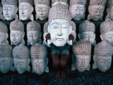 Buy A Shy Young Boy Hiding Behind One of Many Carved Wooden Faces in a Shop Front, Indonesia at AllPosters.com