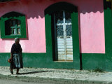 Elderly Woman Walking Past Pink and Green Building, Chiapas, Mexico