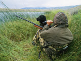 A Hunter Using a Goose Call by a Small Pond in Wyoming