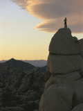 A Climber Watches the Sunset from High Atop a Rock Formation