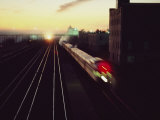A Trans-Canada Railway Train Rushes Down the Tracks at Dusk