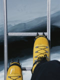 Dizzying View of Crampons Traversing a Ladder in the Khumbu Icefall